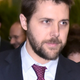 White House advisor Brian Deese walks to attend a meeting at the COP 21 UN Conference in a dark blue and tie in this 2015 file photo.